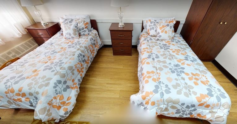 A twin bedroom setup in the assisted living facility