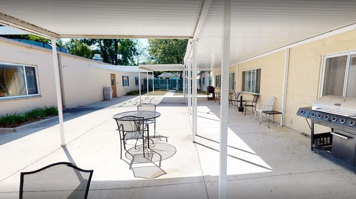 Outdoor seating area with tables and grill