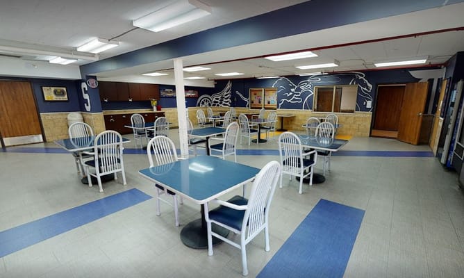 Bright dining room with empty tables and chairs