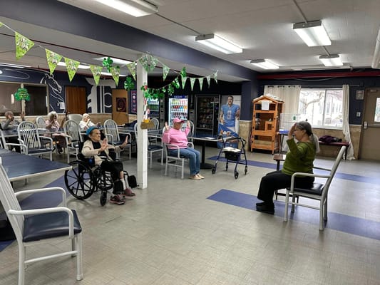 Residents participating in an activity in a community room