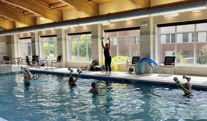 Seniors participating in an aquatic exercise class in a pool