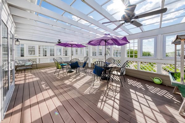 Outdoor deck area with seating and umbrellas