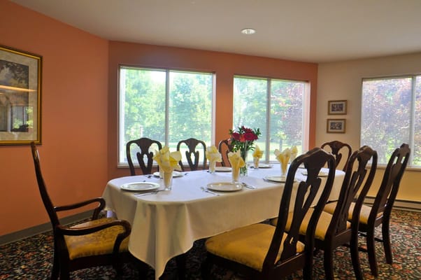 Dining room set for a meal with floral centerpiece