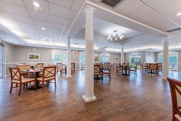 Bright and spacious dining room with wooden tables and chairs