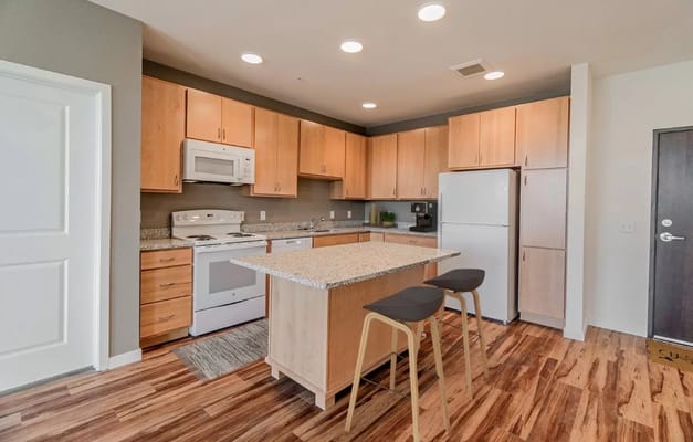 Modern kitchen interior with wooden cabinets and island