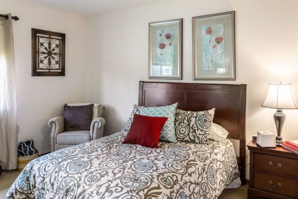 A well-decorated bedroom with a bed and a sitting area