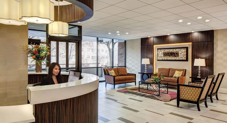 Reception area with seating and a staff member