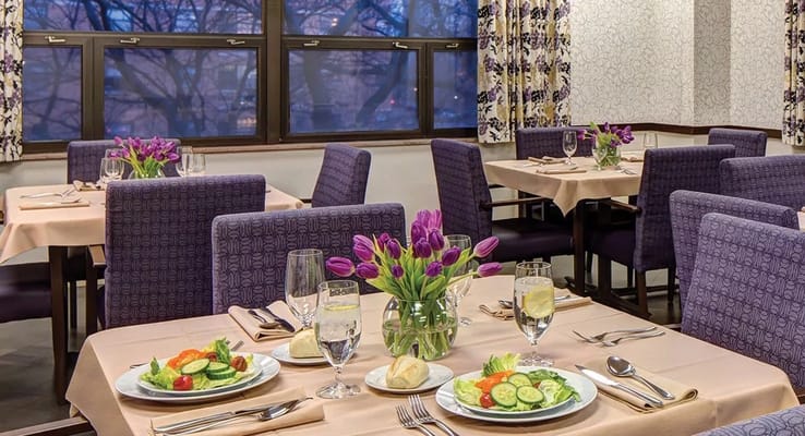 Dining room setup with plates of salad and flowers