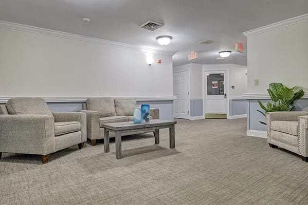 A cozy common area with seating and plants