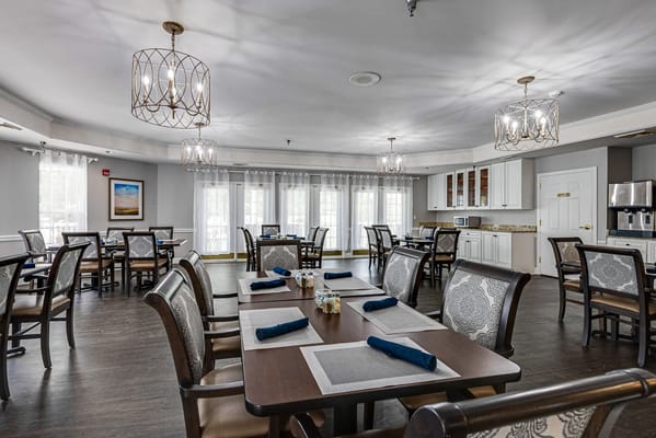 Bright dining area with tables and chairs set up