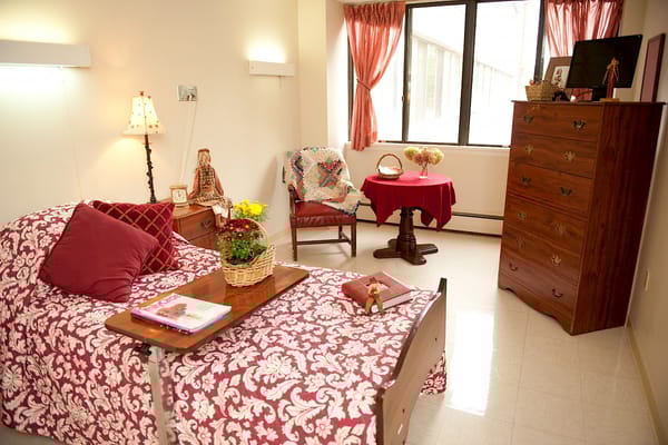 Cozy resident room with floral bedding and personal decor
