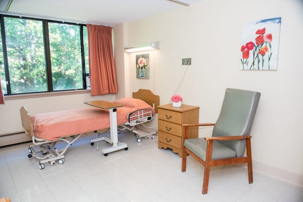 Private resident room with two beds and window