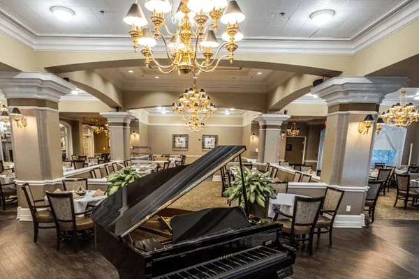 Elegant dining hall with grand piano and chandelier