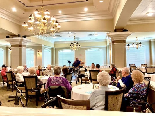 Residents enjoying a live music performance in a common area