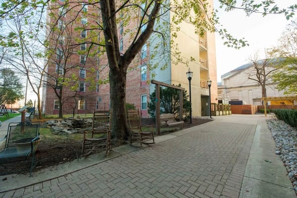 Outdoor garden space with benches and trees at Christian Health Center.