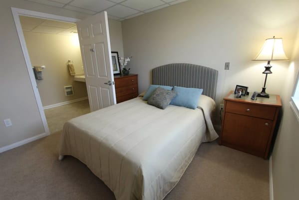 Cozy private bedroom with a bed and nightstand