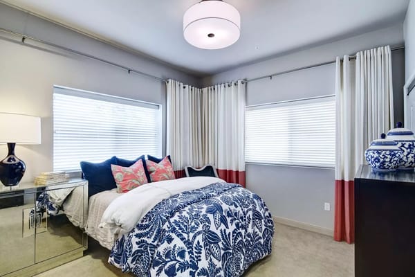 Well-decorated private resident room with a bed and natural light