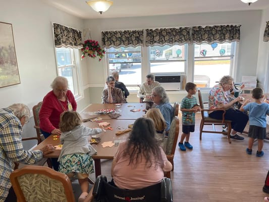 Residents and children engaging in a creative activity together