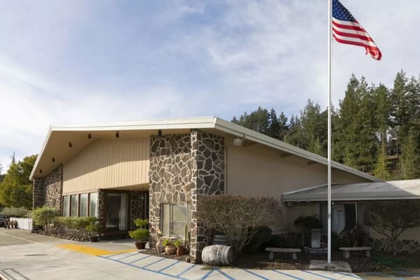 Exterior view of Cloverdale Healthcare Center with American flag
