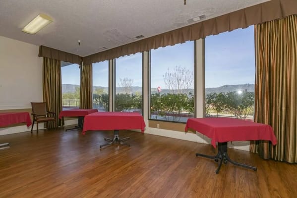 Common area with tables and large windows