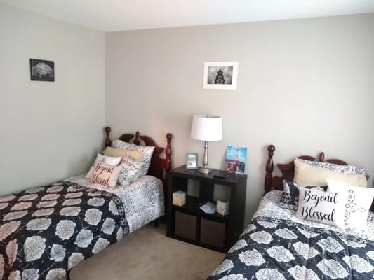 A cozy shared resident room with twin beds and decor