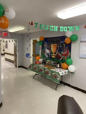 Decorated hallway for a sports-themed event with food table