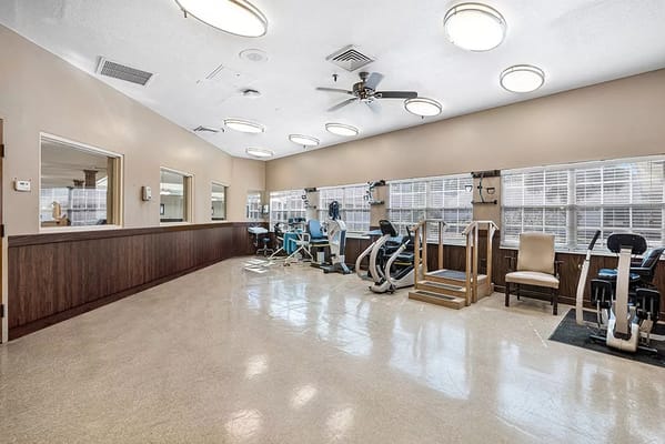 Interior view of a rehabilitation gym with exercise equipment
