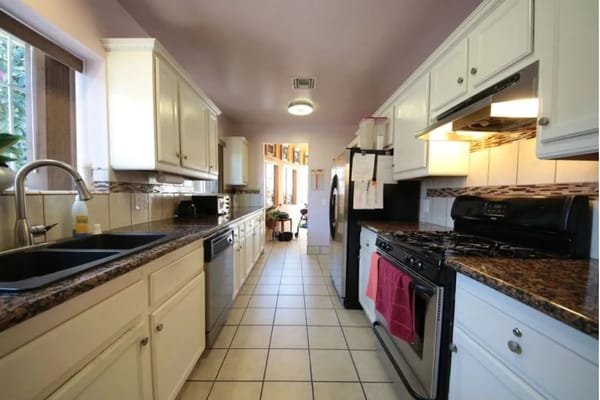 Spacious kitchen with granite countertops and modern appliances.