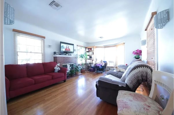 Bright living room with red sofa and TV