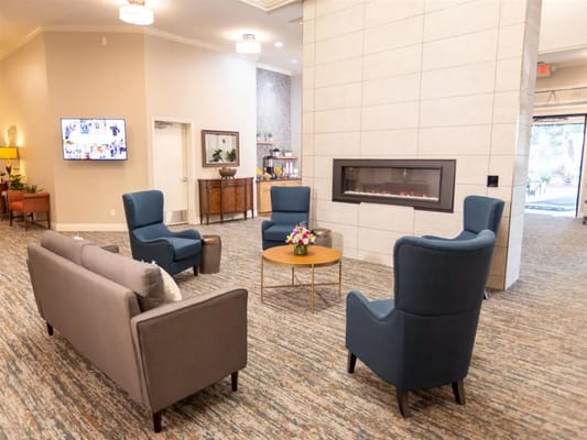 Cozy interior common area with seating and a fireplace