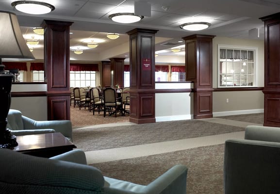 Cozy lobby space with seating and dining area in the background