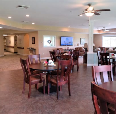 Bright dining area with wooden tables and chairs