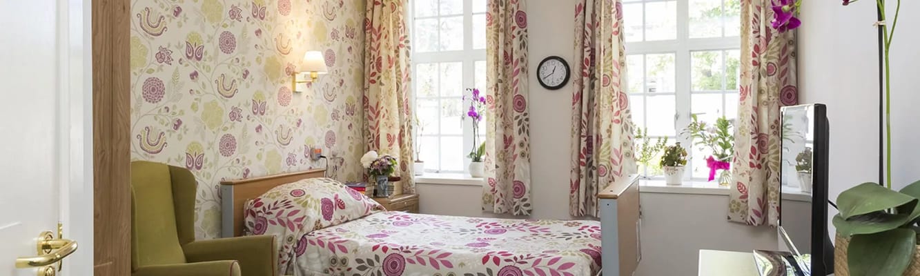 Cozy resident room with floral decor and natural light