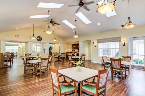 Interior common area with dining tables and natural light