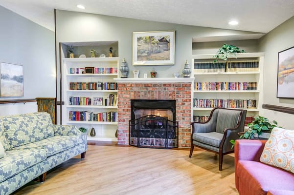 Cozy common area with a fireplace and bookshelves