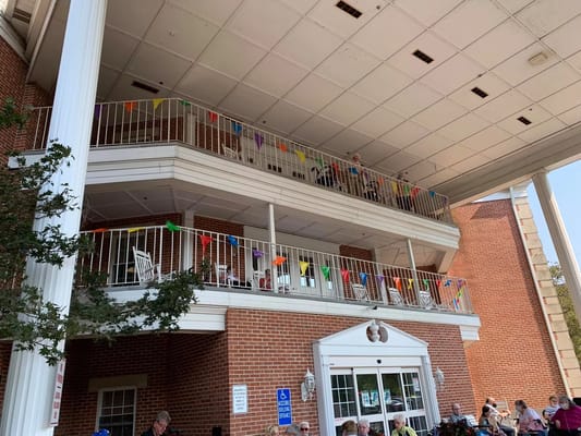 Exterior view of the Colonial Heights facility with residents on the balcony