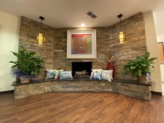 Lobby area with stone fireplace and decorative pillows