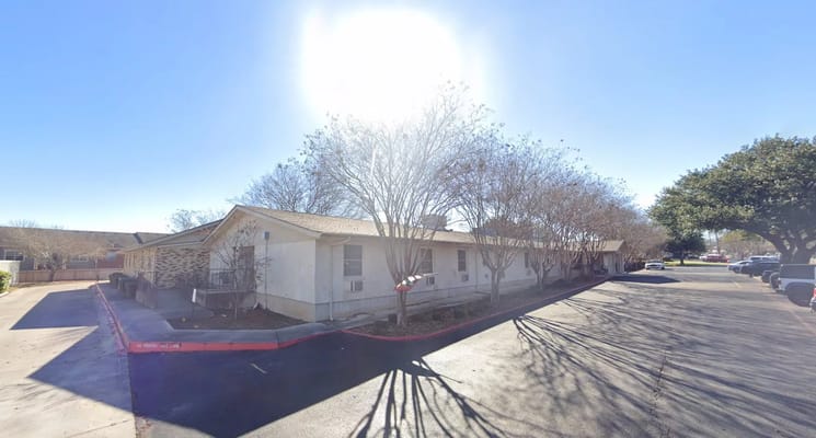 Exterior of Colonial Manor Nursing & Rehabilitation Center on a sunny day