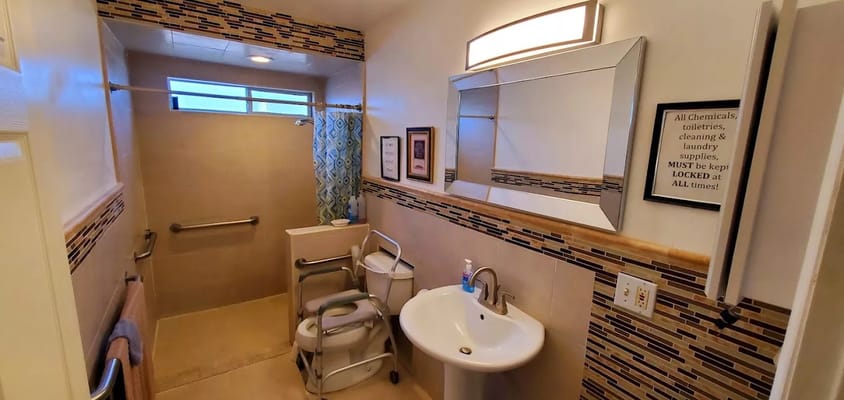 Modern bathroom with safety features and colorful decor.