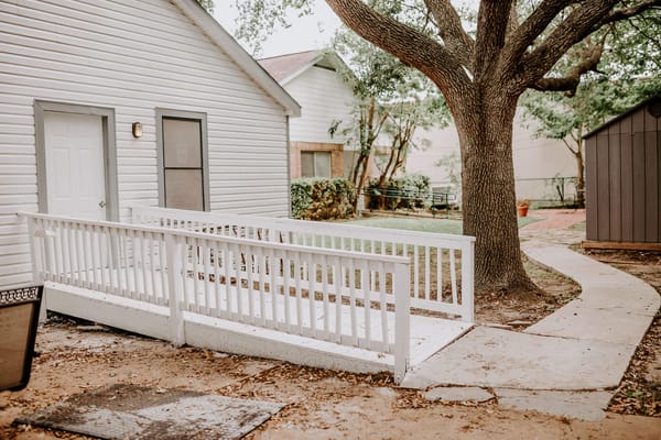 Accessible walkway leading to a building with trees