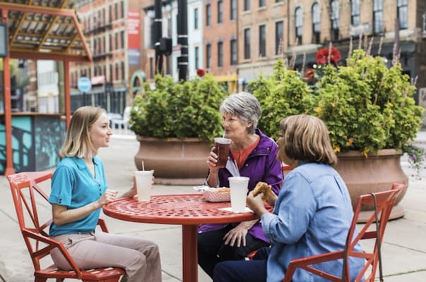Residents enjoying drinks at an outdoor table
