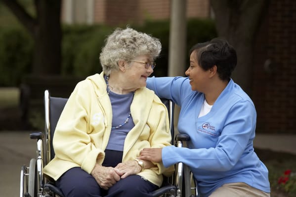 Caregiver interacting with a resident in a wheelchair