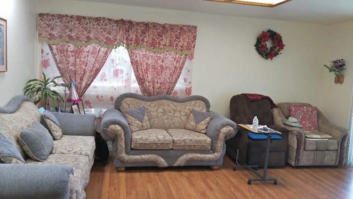 Comfortable living room with floral curtains and couches