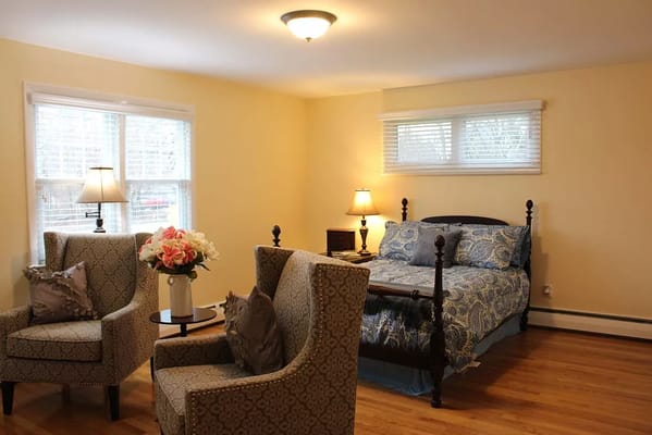 Cozy private room with a bed and armchairs