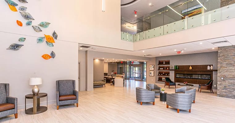 Bright and spacious lobby with seating area and decorative wall art