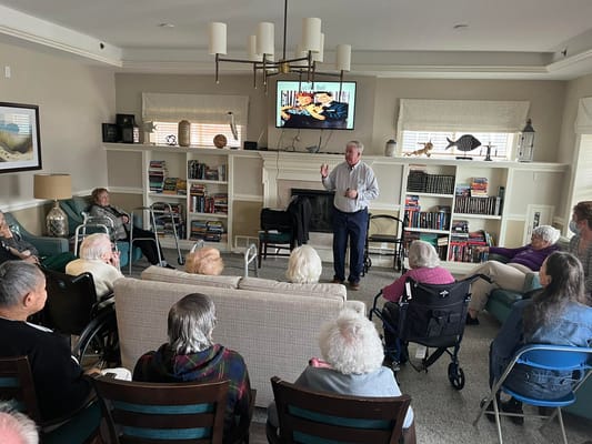 Residents participating in a group discussion led by a speaker.