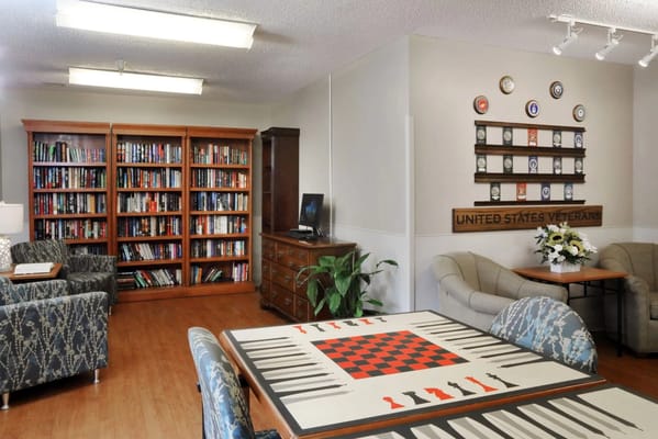Interior common area with library and game table