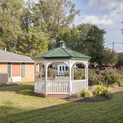 A gazebo in a landscaped garden area
