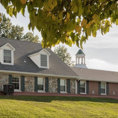 Building exterior view with trees and landscaping