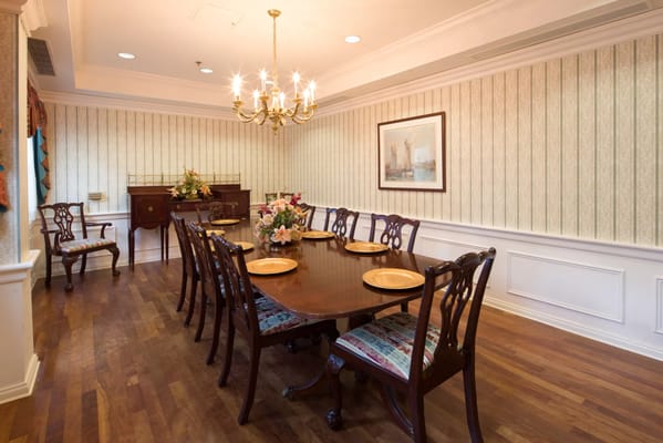 Elegant dining room with a chandelier and floral arrangement